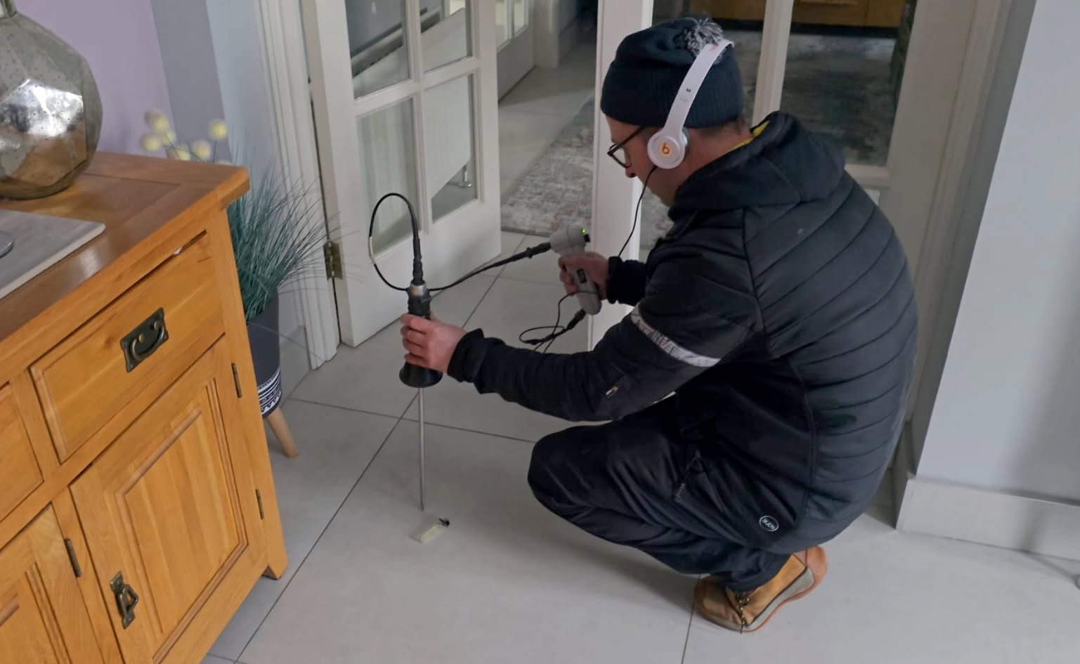 Man using machine to find leak