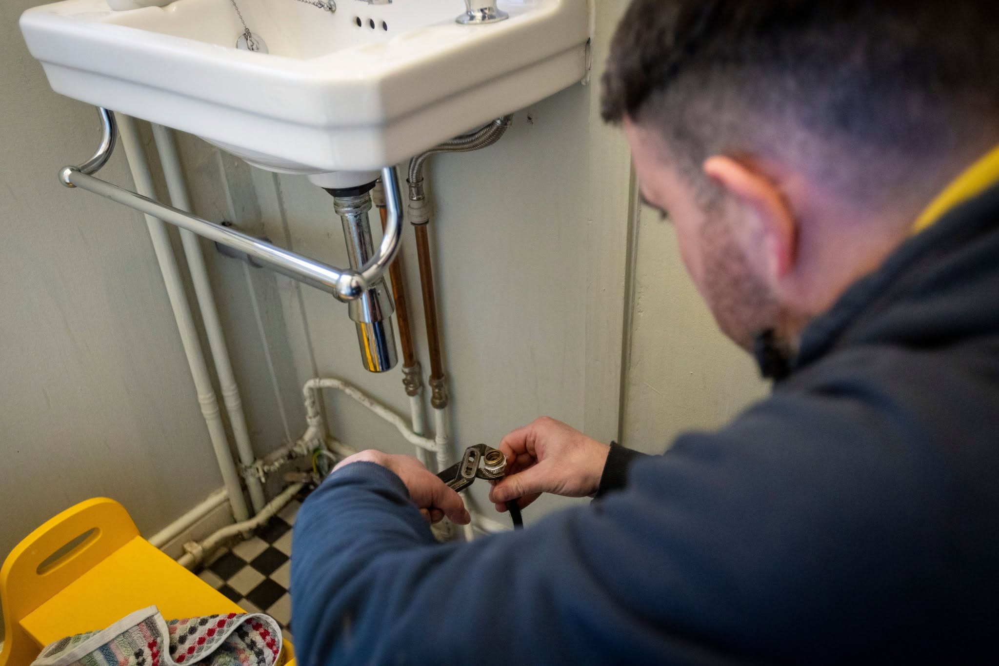 Man fixing leak on sink
